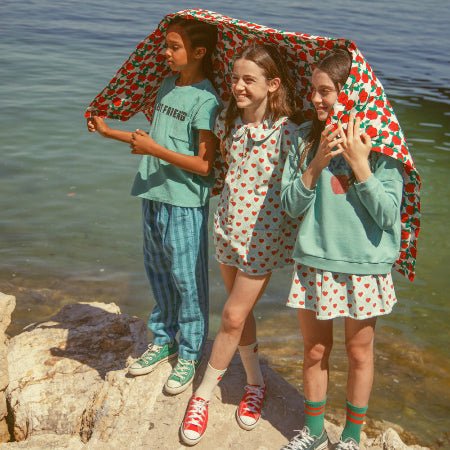 Girl wearing light blue short skirt with red hearts all over