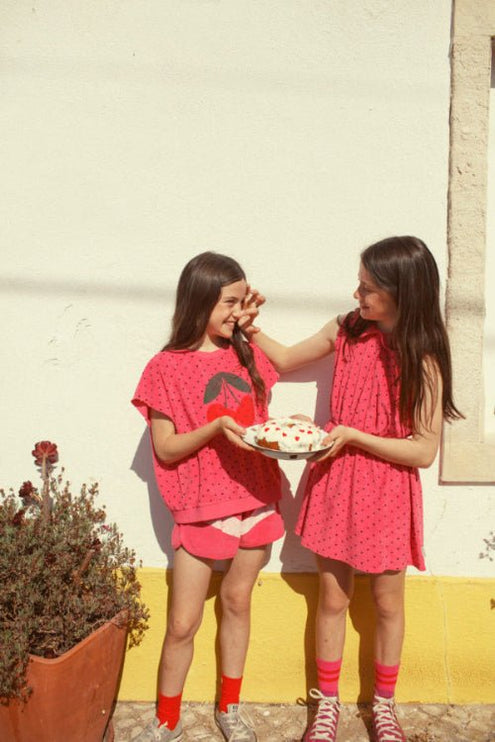 Girl wearing red socks with heart print