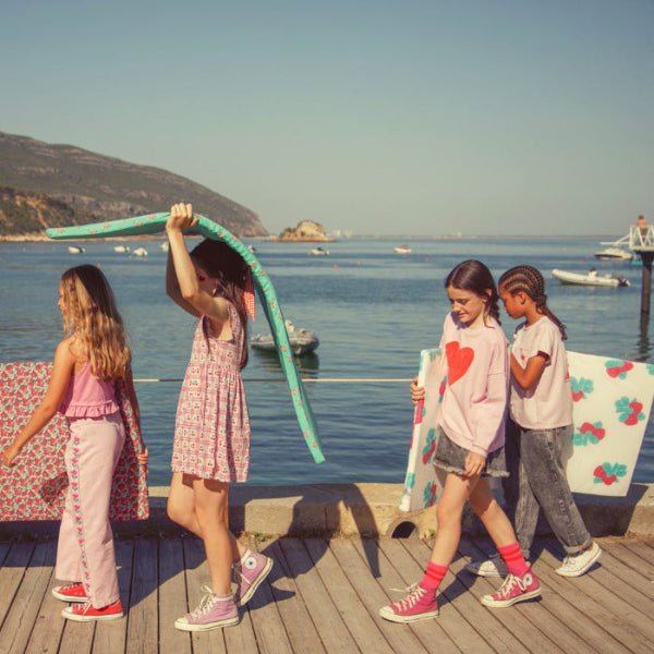 Girl wearing lilac sweatshirt with red heart print