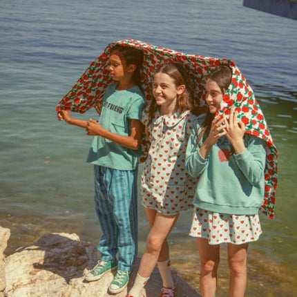 Girl wearing turquoise sweatshirt wirh peace print