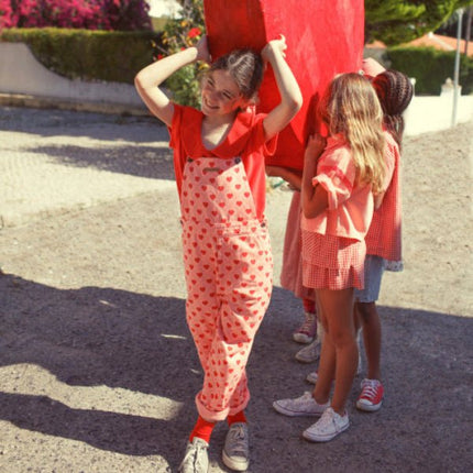 Girl wearing red t-shirt with collar and Amour print