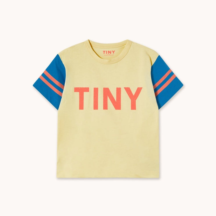 Yellow t-shirt with blue sleeves and red 'TINY' text
