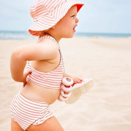 Baby girl wearing Striped cream and  peach bikini set and matching bucket hat