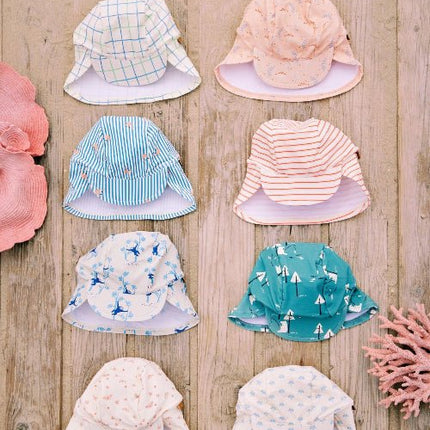 Colorful Baby swim hats arranged on a wooden backgound featuring various print styles