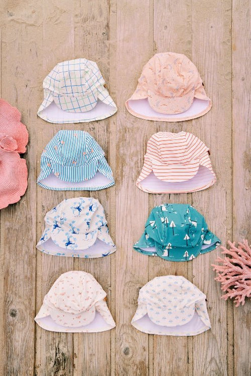 Colorful Baby swim hats arranged on a wooden backgound featuring various print styles