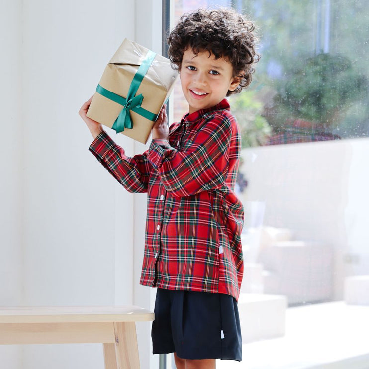 Boy wearing long sleeved tartan shirt