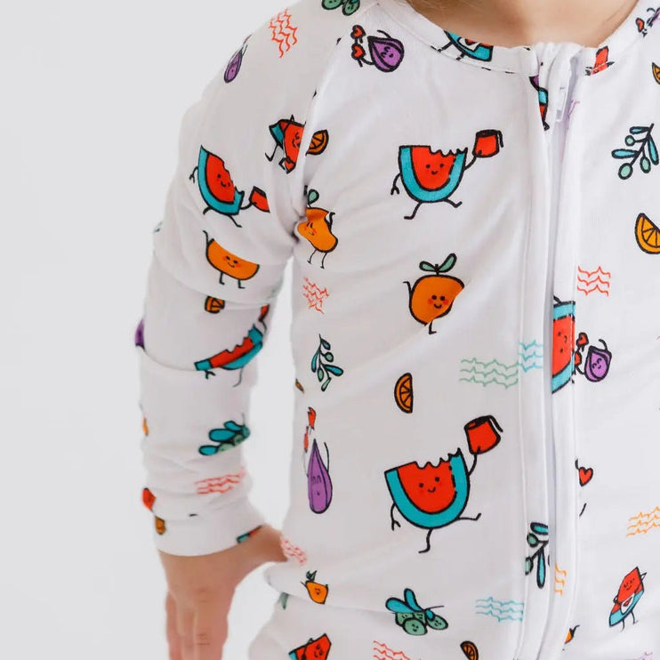 Baby wearing a colorful fruit patterned onesie