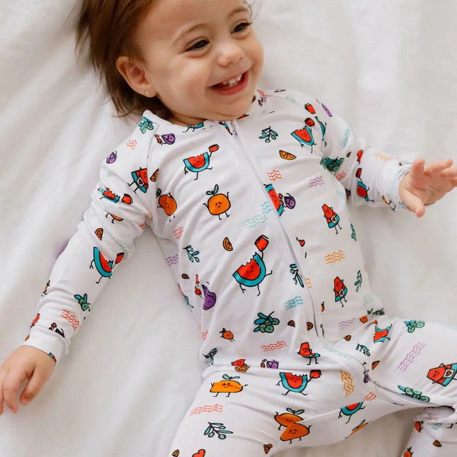 Child wearing a colorful fruit onesie