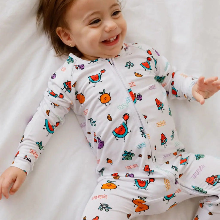 Child wearing a colorful fruit onesie