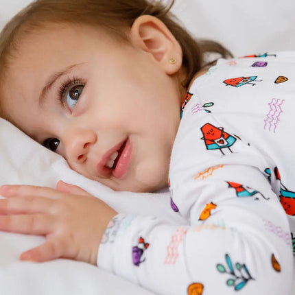 Child wearing a colorful fruit onesie 