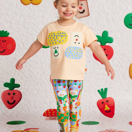 child wearing a peach tshirt with cute abstract detail