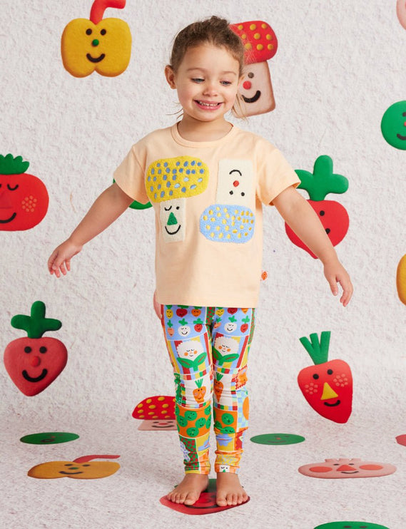 child wearing a peach tshirt with cute abstract detail