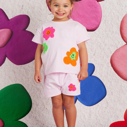 child wearing a tshirt with flower print and matching shorts