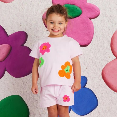 a girl wearing hej blomma tshirt