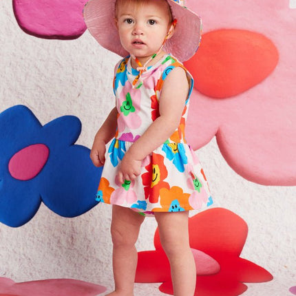 Child in a colorful dress and hat 