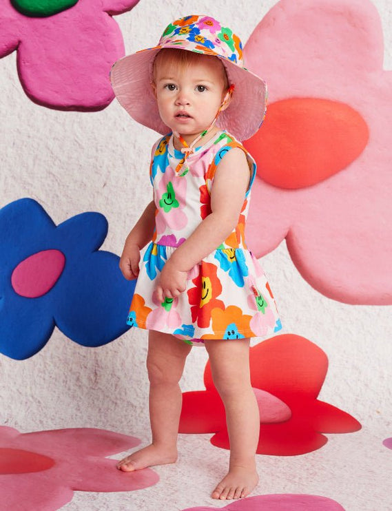 Child in a colorful dress and hat 