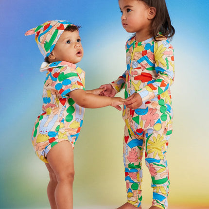 Two children wearing colorful pattern outfits 