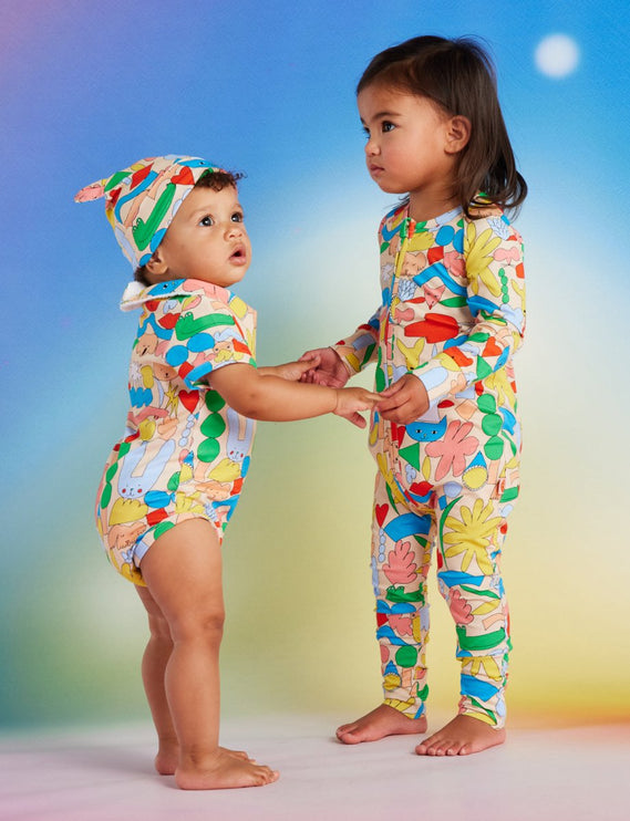 Two children wearing colorful pattern outfits 