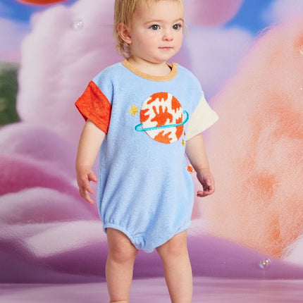 baby wearing short sleeve body suit with planet design