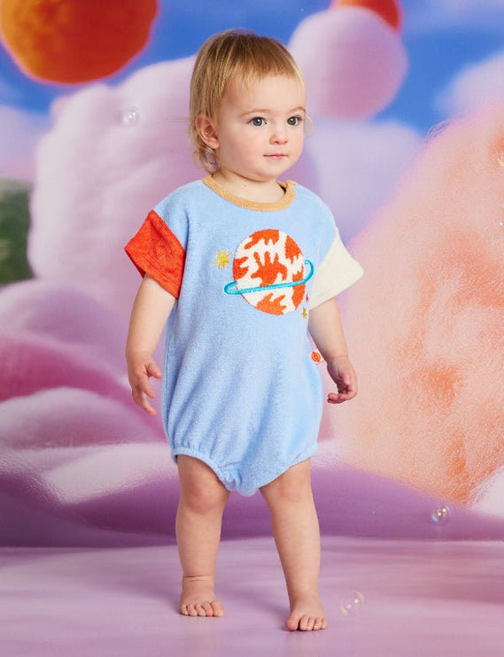 baby wearing short sleeve body suit with planet design