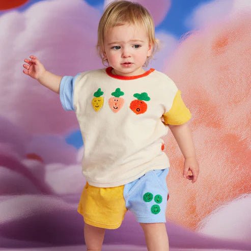 a toddler wearing a terry short pocket patch