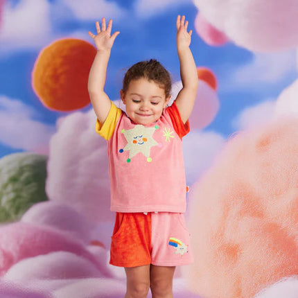 Child in colorful outfit with abstract floral background