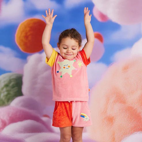 Child in colorful outfit with abstract floral background
