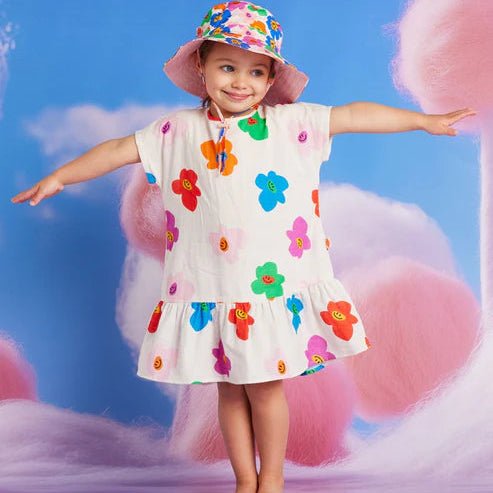 a little girl posed wearing hej blomma wooven dress