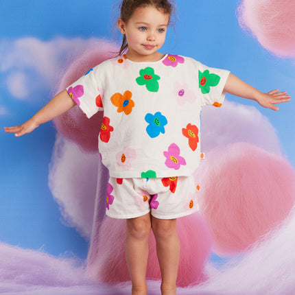 kid wearing matching shirt and short with colorful flower print