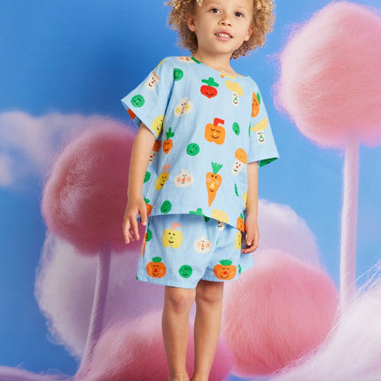Child wearing a colorful outfit with veggie patterns