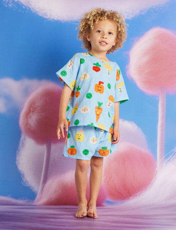 Child wearing a colorful outfit with veggie patterns